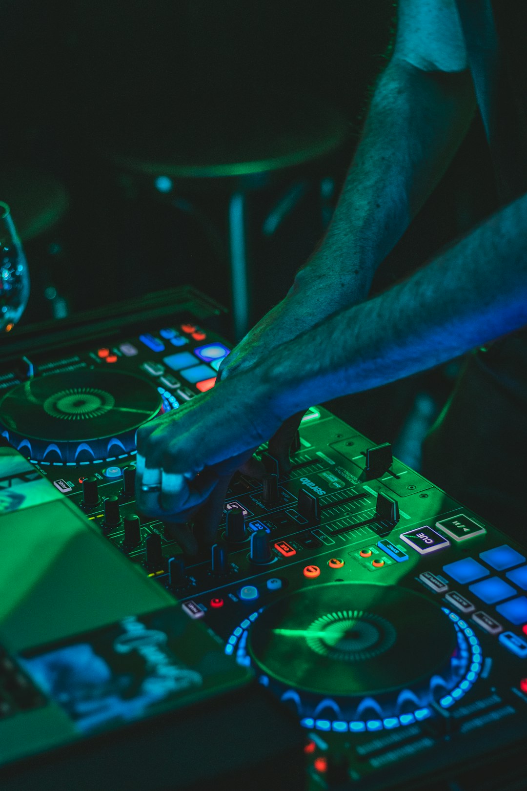 person-playing-audio-mixer-with-green-lights-8oscchpjox4
